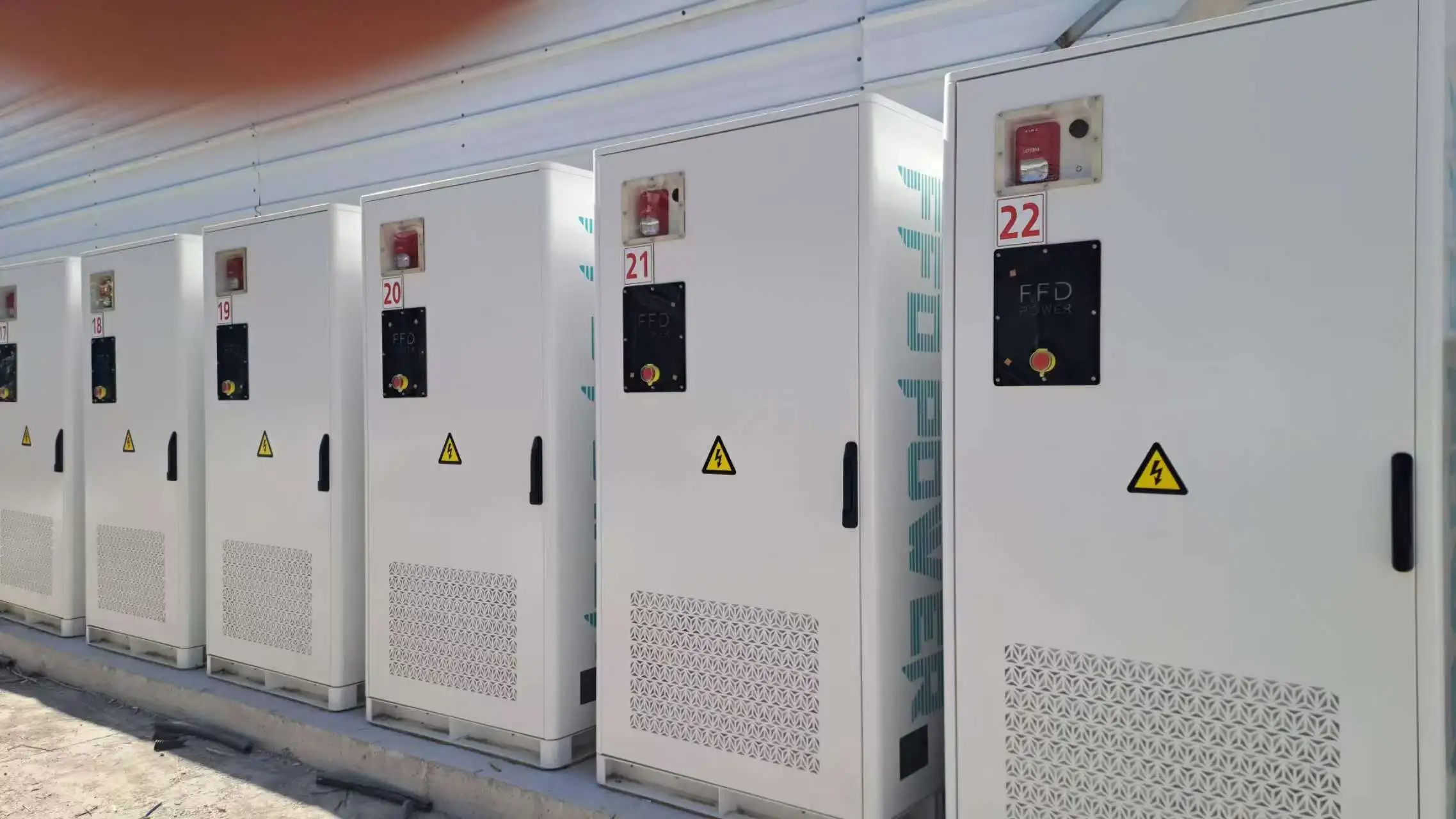 Row of outdoor battery storage cabinets for a 2.2MW/5.1MWh peak shaving and valley filling energy storage project.